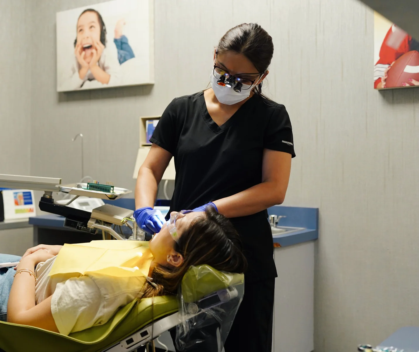 Dr. Kingra treating a patient at Sunnyside Smiles
