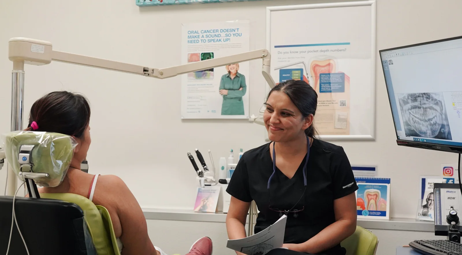 Dr. Kingra consulting with a patient